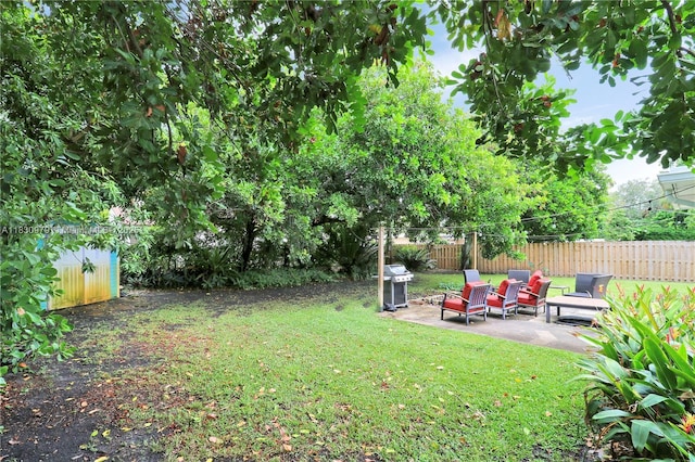 1884 Juno Rd, North Palm Beach, FL 33408 - view of yard featuring a patio area and a storage unit
