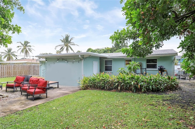 1884 Juno Rd, North Palm Beach, FL 33408 - rear view of house featuring a patio, stucco siding, and an outdoor hangout area