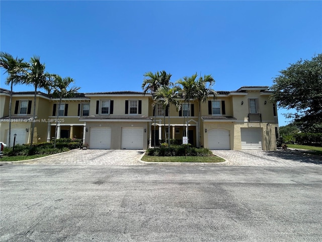 3 Largo Way, Boynton Beach, FL 33426 - townhome / multi-family property with stucco siding, a garage, and driveway
