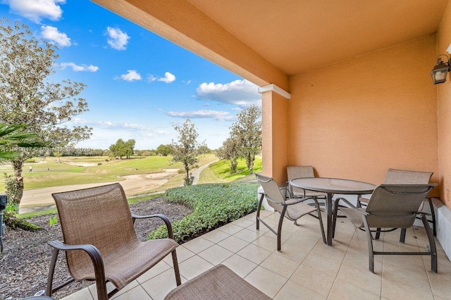 7661 Heritage Crossing Way Unit 102, Kissimmee, FL 34747 - view of patio featuring outdoor dining space and view of golf course