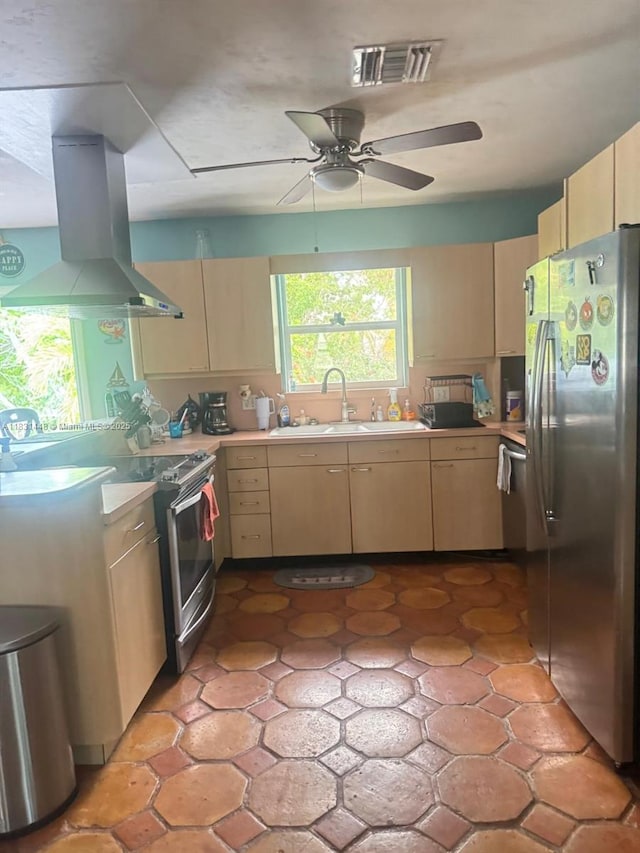 715 E Caribbean Dr E, Lower Keys, FL 33042 - kitchen featuring stainless steel appliances, island exhaust hood, light countertops, a ceiling fan, and light brown cabinets