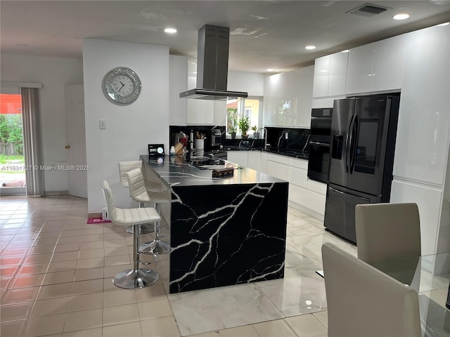 1014 W 68th St, Hialeah, FL 33014 - kitchen with refrigerator with ice dispenser, island range hood, plenty of natural light, a peninsula, and recessed lighting