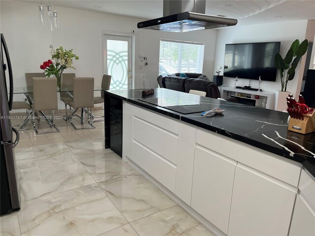 1014 W 68th St, Hialeah, FL 33014 - kitchen with ventilation hood, open floor plan, dark countertops, and white cabinets