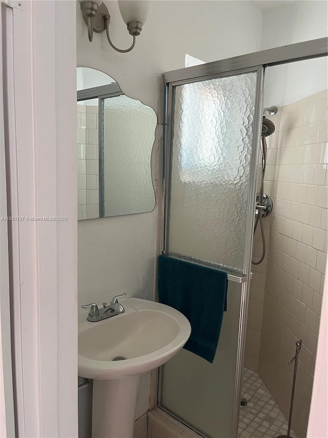 1014 W 68th St, Hialeah, FL 33014 - bathroom featuring a stall shower and a sink