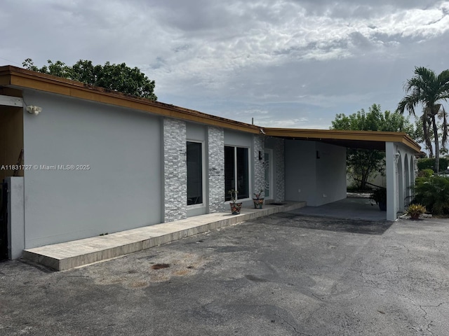 1014 W 68th St, Hialeah, FL 33014 - view of front of property featuring stucco siding and a carport