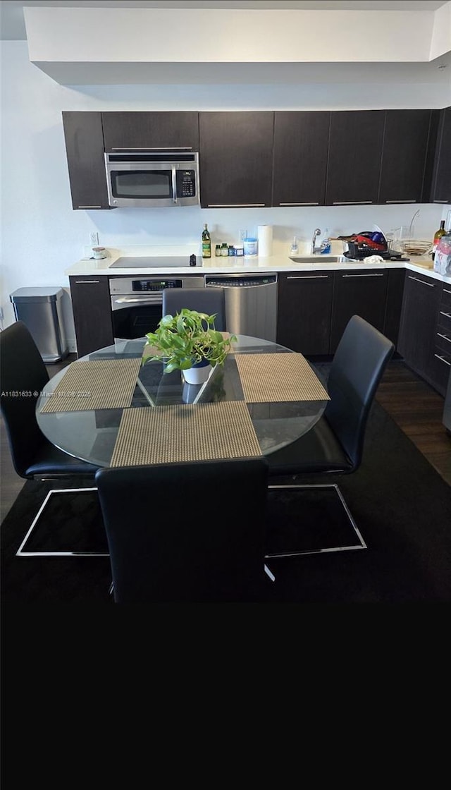 90 SW 3rd St Unit 2214, Miami, FL 33130 - kitchen with appliances with stainless steel finishes, light countertops, modern cabinets, and wood finished floors