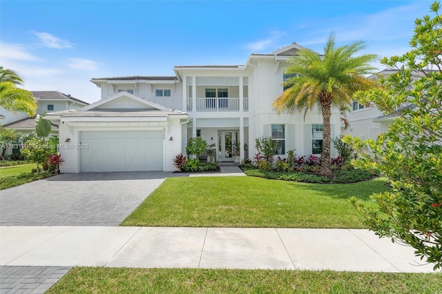 9369 Crestview Cir, Palm Beach Gardens, FL 33412 - view of front facade featuring a balcony, french doors, a garage, decorative driveway, and a front yard
