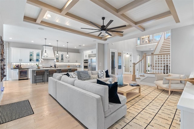 9369 Crestview Cir, Palm Beach Gardens, FL 33412 - living area featuring beverage cooler, coffered ceiling, ceiling fan, stairs, and beam ceiling