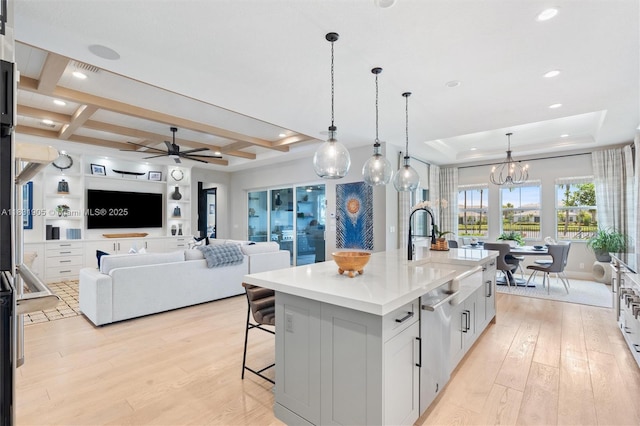 9369 Crestview Cir, Palm Beach Gardens, FL 33412 - kitchen with light wood-style flooring, a kitchen breakfast bar, a raised ceiling, light countertops, and beam ceiling