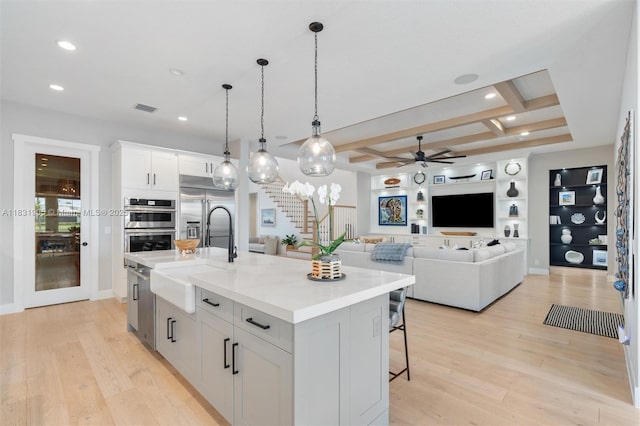 9369 Crestview Cir, Palm Beach Gardens, FL 33412 - kitchen featuring stainless steel appliances, a ceiling fan, light wood finished floors, a kitchen island with sink, and recessed lighting