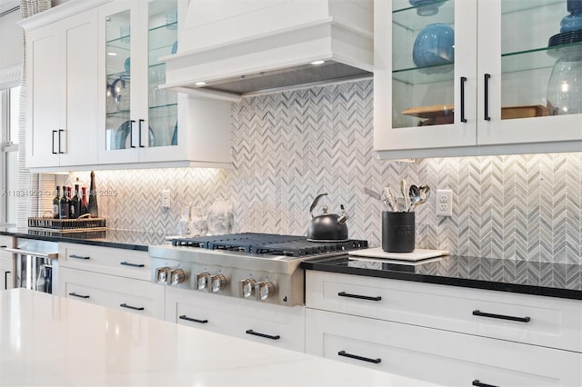 9369 Crestview Cir, Palm Beach Gardens, FL 33412 - kitchen with premium range hood, stainless steel gas cooktop, backsplash, and white cabinetry