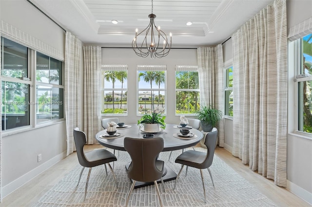 9369 Crestview Cir, Palm Beach Gardens, FL 33412 - dining area with a chandelier, a tray ceiling, wood finished floors, and ornamental molding