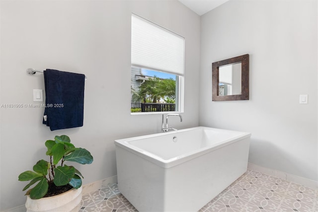9369 Crestview Cir, Palm Beach Gardens, FL 33412 - bathroom with a freestanding bath and baseboards