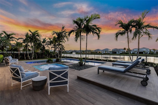 9369 Crestview Cir, Palm Beach Gardens, FL 33412 - pool at dusk featuring a jacuzzi and a wooden deck