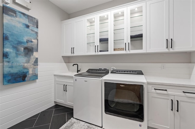 9369 Crestview Cir, Palm Beach Gardens, FL 33412 - laundry area featuring cabinet space, washer and dryer, wainscoting, wooden walls, and dark tile patterned floors