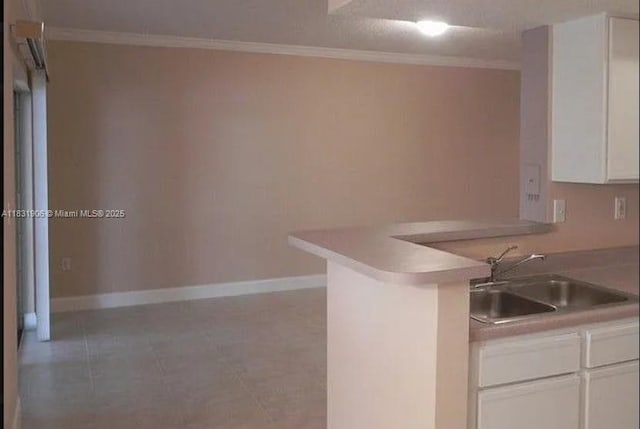 160 SW 117th Ter Unit 6102, Pembroke Pines, FL 33025 - kitchen with ornamental molding, white cabinetry, a peninsula, and light countertops