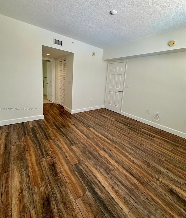 55 Merrick Way Unit 711, Coral Gables, FL 33134 - spare room with dark wood finished floors, a textured ceiling, and a smoke detector