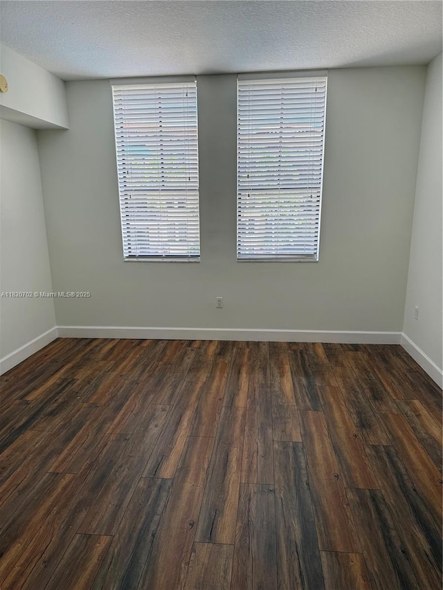 55 Merrick Way Unit 711, Coral Gables, FL 33134 - spare room with dark wood finished floors and a textured ceiling