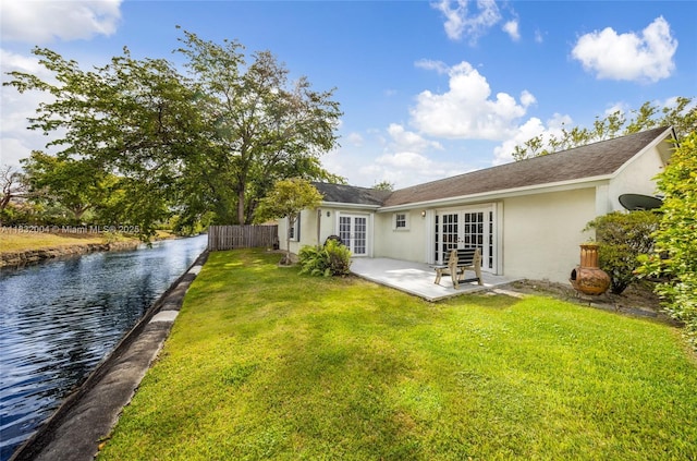 8031 NW 47th Ct, Lauderhill, FL 33351 - rear view of property with french doors, stucco siding, a patio area, and a water view