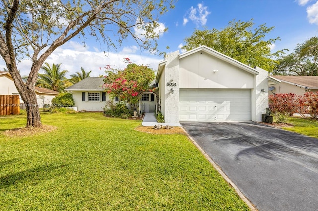 8031 NW 47th Ct, Lauderhill, FL 33351 - view of front facade with asphalt driveway, a garage, and stucco siding