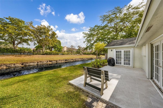 8031 NW 47th Ct, Lauderhill, FL 33351 - view of green lawn featuring french doors, a patio, and a water view