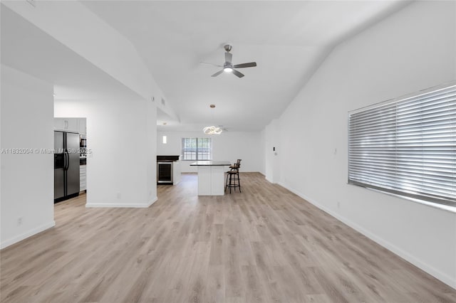 8031 NW 47th Ct, Lauderhill, FL 33351 - unfurnished living room with a ceiling fan, vaulted ceiling, and light wood finished floors