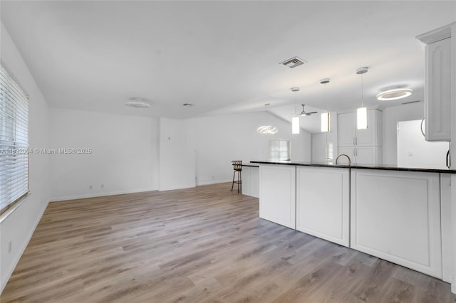 8031 NW 47th Ct, Lauderhill, FL 33351 - unfurnished living room with light wood-type flooring, vaulted ceiling, and ceiling fan