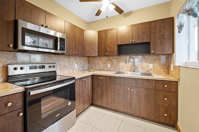 524 NW 88th St, El Portal, FL 33150 - kitchen with appliances with stainless steel finishes, open shelves, light countertops, decorative backsplash, and ceiling fan