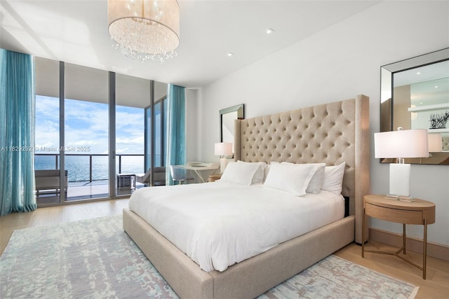 9703 Collins Ave Unit Ph-12, Bal Harbour, FL 33154 - bedroom with access to outside, wood finished floors, expansive windows, and a chandelier