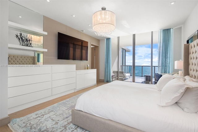 9703 Collins Ave Unit Ph-12, Bal Harbour, FL 33154 - bedroom with expansive windows, access to exterior, wood finished floors, and a chandelier