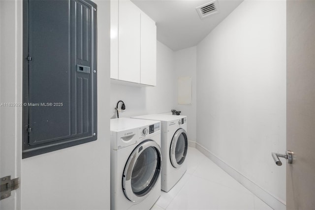 9703 Collins Ave Unit Ph-12, Bal Harbour, FL 33154 - laundry room with washing machine and dryer, light tile patterned floors, and cabinet space