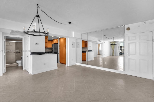 10350 W Bay Harbor Dr Unit 8F, Bay Harbor Islands, FL 33154 - unfurnished living room featuring a chandelier and light tile patterned floors