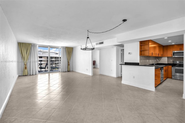 10350 W Bay Harbor Dr Unit 8F, Bay Harbor Islands, FL 33154 - unfurnished living room with light tile patterned floors and expansive windows