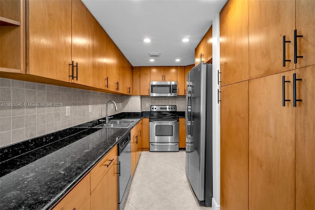 10350 W Bay Harbor Dr Unit 8F, Bay Harbor Islands, FL 33154 - kitchen with appliances with stainless steel finishes, backsplash, light tile patterned flooring, dark stone counters, and brown cabinetry
