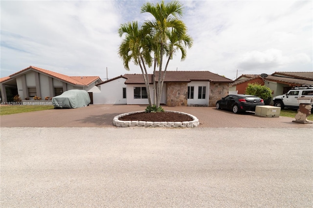 13250 SW 29th Ter, Miami, FL 33175 - ranch-style house with curved driveway, a tiled roof, and stucco siding