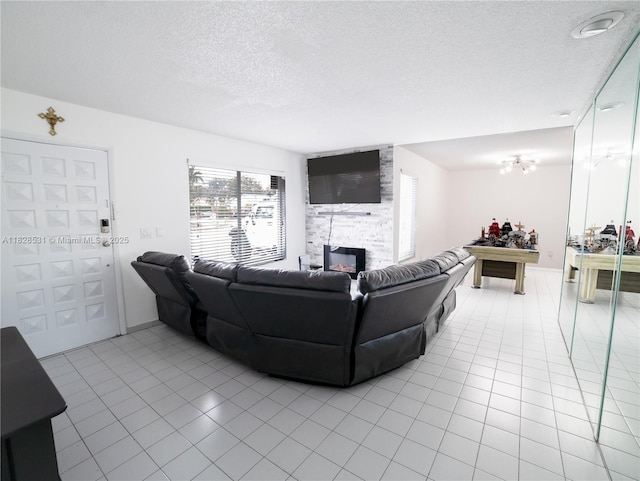 13250 SW 29th Ter, Miami, FL 33175 - living room featuring light tile patterned flooring, a textured ceiling, and a fireplace