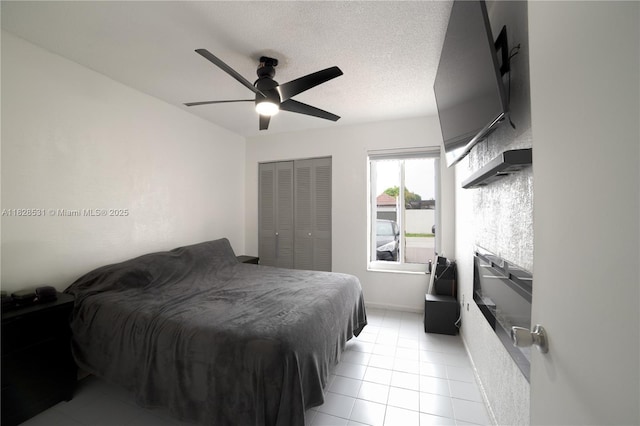 13250 SW 29th Ter, Miami, FL 33175 - bedroom featuring light tile patterned flooring, a closet, a ceiling fan, and a textured ceiling