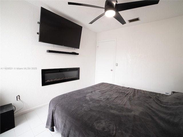 13250 SW 29th Ter, Miami, FL 33175 - bedroom featuring a glass covered fireplace and a ceiling fan