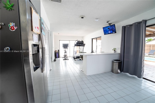 13250 SW 29th Ter, Miami, FL 33175 - kitchen featuring stainless steel fridge, tile patterned flooring, and a textured ceiling