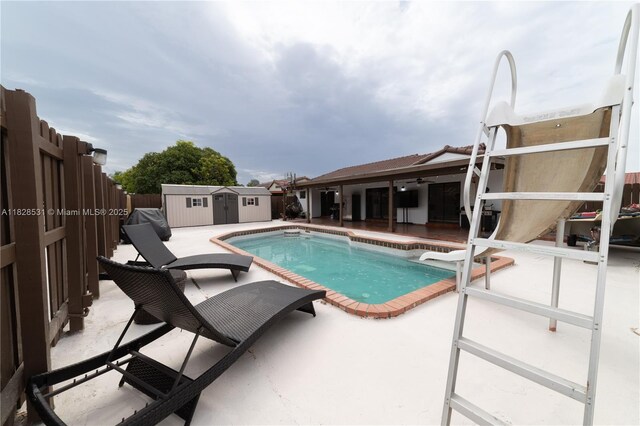 13250 SW 29th Ter, Miami, FL 33175 - view of pool featuring a patio, a storage shed, and a fenced backyard