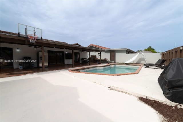 13250 SW 29th Ter, Miami, FL 33175 - view of pool featuring a water slide, a patio area, a fenced backyard, ceiling fan, and grilling area