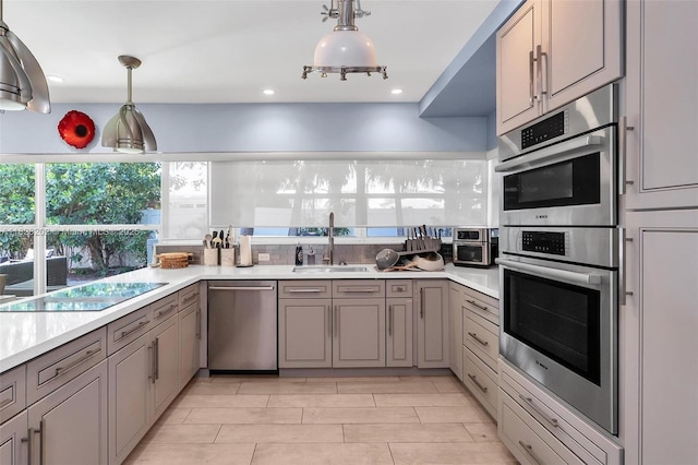 3210 Dover Rd, Pompano Beach, FL 33062 - kitchen featuring appliances with stainless steel finishes, gray cabinetry, light countertops, pendant lighting, and recessed lighting