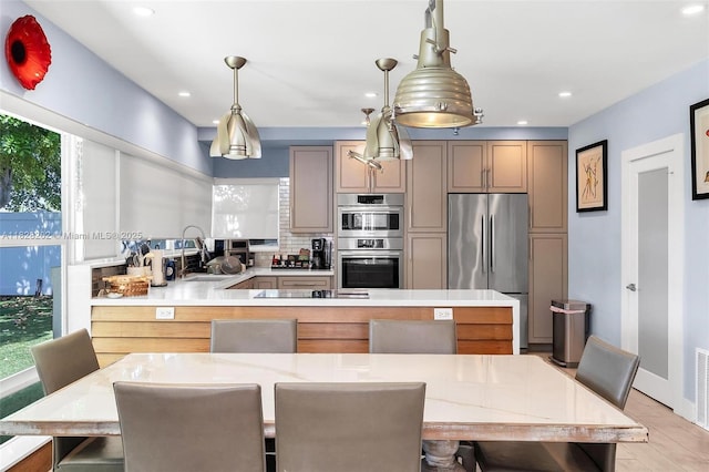 3210 Dover Rd, Pompano Beach, FL 33062 - kitchen featuring stainless steel appliances, a peninsula, light countertops, recessed lighting, and backsplash