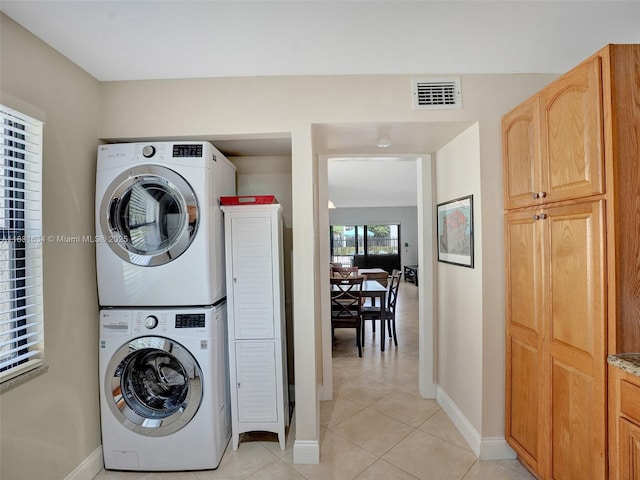245 SE 10th St Unit 4B, Deerfield Beach, FL 33441 - washroom featuring stacked washer and clothes dryer and light tile patterned floors