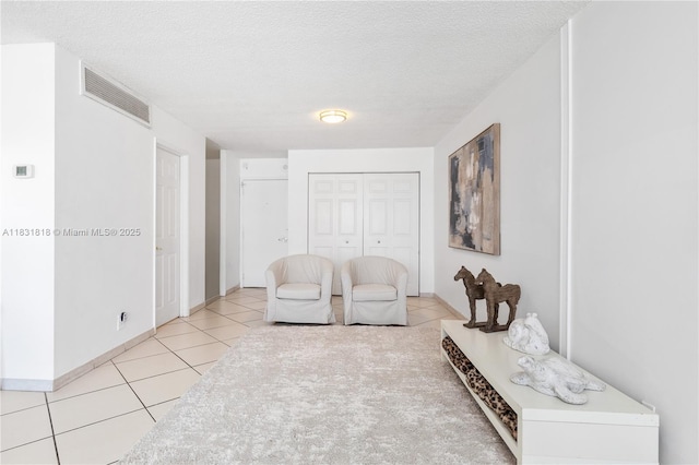6770 Indian Creek Dr Unit 7A, Miami Beach, FL 33141 - sitting room with light tile patterned floors and a textured ceiling
