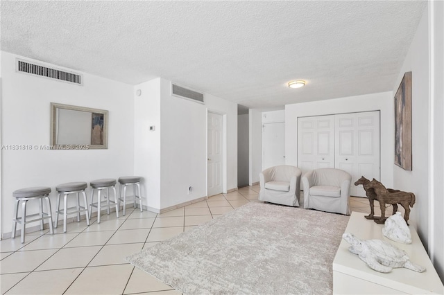 6770 Indian Creek Dr Unit 7A, Miami Beach, FL 33141 - living room featuring tile patterned floors and a textured ceiling