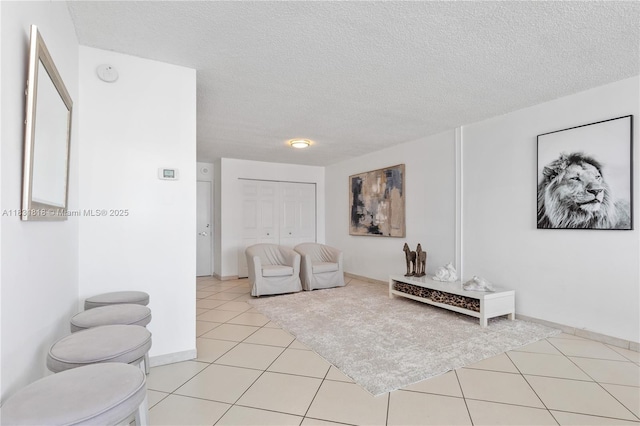 6770 Indian Creek Dr Unit 7A, Miami Beach, FL 33141 - living area featuring a textured ceiling and light tile patterned floors