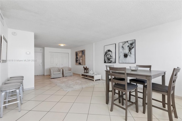 6770 Indian Creek Dr Unit 7A, Miami Beach, FL 33141 - dining area featuring a textured ceiling and light tile patterned floors