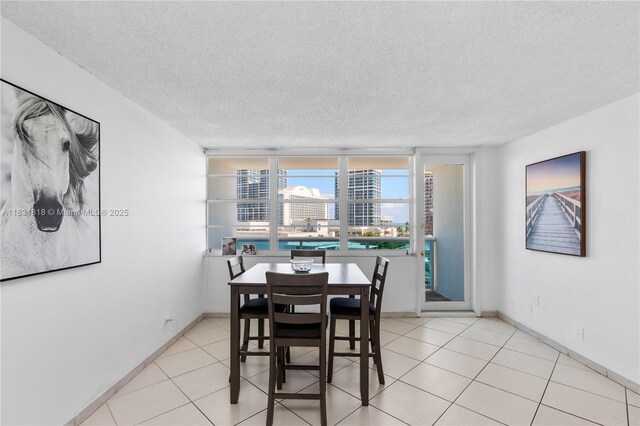 6770 Indian Creek Dr Unit 7A, Miami Beach, FL 33141 - dining room with a textured ceiling, light tile patterned floors, and a city view