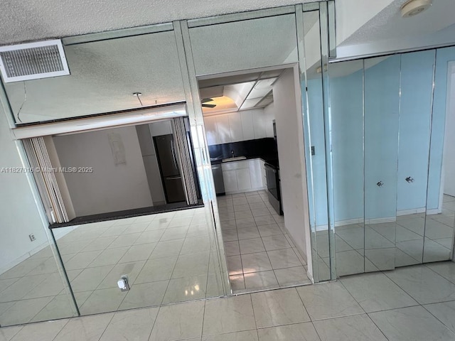 2101 S Ocean Dr Unit 2603, Hollywood, FL 33019 - corridor featuring light tile patterned flooring and a textured ceiling